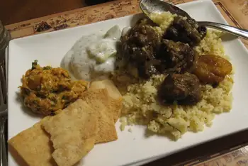 Serve from the pot, scattered with toasted almonds and cilantro, with couscous or torn bread for the sauce.