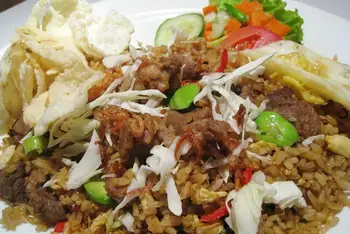 Serve the rice mounded, egg on top, crackers, cucumber and tomato alongside.