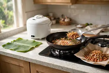 Fry the anchovies in shallow oil until crisp and golden; drain. Fry the peanuts in the same oil until golden; drain and salt both.