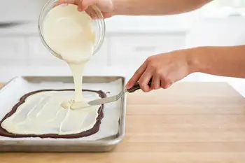 Melt the white chocolate the same way, gently, and stir in the peppermint extract. Let it cool for 2 minutes so it does not melt the layer below, then