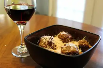 Toss the spaghetti through a ladleful of sauce with a splash of pasta water until glossy. Serve in warm bowls, meatballs on top, sauce over, and Parme